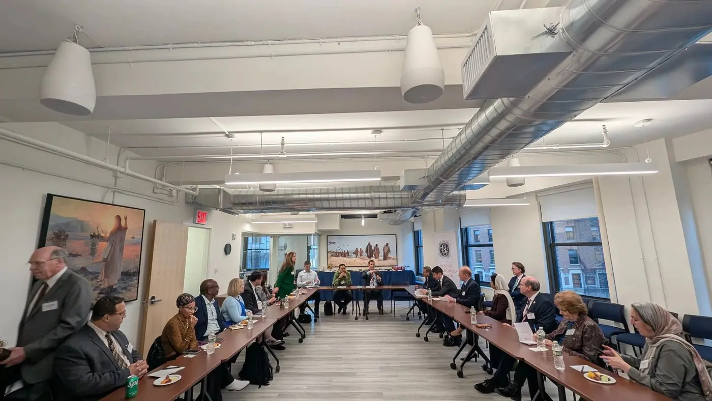 Consular representatives seated around a table during a Society roundtable.